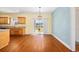 Bright dining area with wood floors, decorative lighting, and access to the patio at 237 Copperwood Loop, Conway, SC 29526
