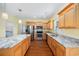 Bright kitchen features granite countertops, stainless steel appliances and wood flooring at 237 Copperwood Loop, Conway, SC 29526