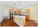 Bright kitchen with an island, stainless steel appliances, and wooden cabinets at 237 Copperwood Loop, Conway, SC 29526