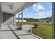 Relaxing screened-in porch with ceiling fan, offering views of the landscaped backyard and clear blue skies at 237 Copperwood Loop, Conway, SC 29526