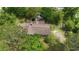Aerial view of house displaying overgrown landscaping and roof in need of repair at 2560 Wise Rd., Conway, SC 29526