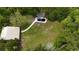 Aerial view of a private backyard featuring a covered pool, a deck, and mature trees at 2560 Wise Rd., Conway, SC 29526