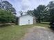 Back exterior view of the home, with vinyl siding, brick accents, and a gravel parking area at 2560 Wise Rd., Conway, SC 29526