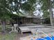 Backyard deck attached to brick home, leading to a pool area, showcasing outdoor living space at 2560 Wise Rd., Conway, SC 29526