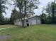 Backyard garage with double doors and ample storage, located on a spacious lot with mature trees at 2560 Wise Rd., Conway, SC 29526