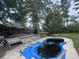Backyard pool with deck needs maintenance, set in a spacious yard surrounded by mature trees at 2560 Wise Rd., Conway, SC 29526