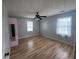Bright bedroom with hardwood floors, ceiling fan, and two windows at 2560 Wise Rd., Conway, SC 29526