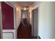 Long hallway with wood floors and neutral walls that leads to various rooms at 2560 Wise Rd., Conway, SC 29526