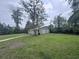 Metal two-car shed stands in the grassy backyard, with a walkway leading to it at 2560 Wise Rd., Conway, SC 29526