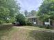 Side view of a brick home surrounded by greenery and trees with a stone walkway at 2560 Wise Rd., Conway, SC 29526