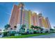 A striking high-rise condo building featuring colorful architecture and lush landscaping in a desirable location at 2711 S Ocean Blvd. # 1917, North Myrtle Beach, SC 29582