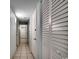 Hallway with beige tile floors, white doors and a closet with white louvered doors at 2711 S Ocean Blvd. # 1917, North Myrtle Beach, SC 29582