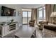Inviting living room featuring comfortable seating, a large TV, and a sliding door to an outside balcony at 2711 S Ocean Blvd. # 1917, North Myrtle Beach, SC 29582