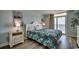 Relaxing bedroom with soft lighting, and balcony access showcasing outdoor scenery at 2711 S Ocean Blvd. # 1917, North Myrtle Beach, SC 29582