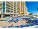Multi-story building with a pool and lounge chairs on the deck at 2711 S Ocean Blvd. # 1917, North Myrtle Beach, SC 29582
