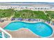 Aerial view of sparkling blue pool with lounge chairs overlooking the beach at 2711 S Ocean Blvd. # 1917, North Myrtle Beach, SC 29582