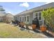 A stone patio with outdoor seating, grill, and potted plants offers outdoor living and entertaining at 3053 Chesterwood Ct., Myrtle Beach, SC 29579