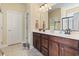 Bathroom with double vanity, framed mirror, tile floor, and linen closet, bright lighting at 3053 Chesterwood Ct., Myrtle Beach, SC 29579