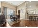 Dining room featuring hardwood floors, a chandelier, and a large window with natural light and decorative curtains at 3053 Chesterwood Ct., Myrtle Beach, SC 29579