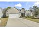 Charming single-story home with a two-car garage, well-maintained lawn, and inviting curb appeal at 3053 Chesterwood Ct., Myrtle Beach, SC 29579