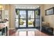 Spacious foyer with hardwood floors, wreath decorated glass doors, and natural light streaming in at 3053 Chesterwood Ct., Myrtle Beach, SC 29579