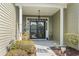 Inviting front porch with tasteful decor and a well-maintained walkway with manicured landscaping at 3053 Chesterwood Ct., Myrtle Beach, SC 29579