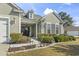 A charming exterior view shows the home's well-manicured front yard, garden, and inviting entryway at 3053 Chesterwood Ct., Myrtle Beach, SC 29579