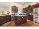 Spacious kitchen featuring granite countertops, stainless steel appliances, dark wood cabinetry, and a center island at 3053 Chesterwood Ct., Myrtle Beach, SC 29579