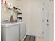 This laundry room includes white washer and dryer units with overhead shelving for storage at 3053 Chesterwood Ct., Myrtle Beach, SC 29579