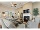Cozy living room featuring a fireplace, ceiling fan, and comfortable seating with neutral colored walls and decor at 3053 Chesterwood Ct., Myrtle Beach, SC 29579