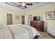 Main bedroom with ceiling fan, hardwood furnishings, and large dresser, view of ensuite bath at 3053 Chesterwood Ct., Myrtle Beach, SC 29579