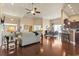 Open floor plan featuring hardwood floors, a dining area, and living room with a ceiling fan and natural light at 3053 Chesterwood Ct., Myrtle Beach, SC 29579