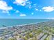Expansive aerial view of a beachfront community and ocean with pier, highlighting the residential area and coastline at 311 Surfside Dr., Surfside Beach, SC 29575