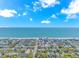 Panoramic aerial view of a coastal town with a pier extending into the ocean under a sunny, partly cloudy sky at 311 Surfside Dr., Surfside Beach, SC 29575