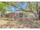 View of a backyard with a brick home, a small patio, and chain link fence at 311 Surfside Dr., Surfside Beach, SC 29575