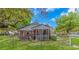 Backyard with a brick house and chain-link fence, plus a screened in patio at 311 Surfside Dr., Surfside Beach, SC 29575