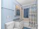 Cozy bathroom features a vanity, sink, toilet, and shower with curtain at 311 Surfside Dr., Surfside Beach, SC 29575