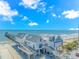 Surfside Beach Pier featuring modern architecture with stairs and ramps, set against a blue sky and ocean backdrop at 311 Surfside Dr., Surfside Beach, SC 29575