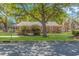 Charming brick home with a metal roof, mature landscaping, and a red shed at 311 Surfside Dr., Surfside Beach, SC 29575