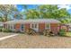 Charming brick home with green lawn and trimmed shrubs at 311 Surfside Dr., Surfside Beach, SC 29575