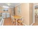 The kitchen has appliances next to an eat-in wooden table and chairs at 311 Surfside Dr., Surfside Beach, SC 29575