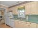 View of the kitchen with a window over the sink, showcasing ample counter space and storage at 311 Surfside Dr., Surfside Beach, SC 29575