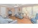 Bright living room featuring a comfortable gray couch and natural light from large windows at 311 Surfside Dr., Surfside Beach, SC 29575