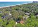 Aerial view of the property nestled among lush trees near the ocean at 412 43Rd Ave. N, Myrtle Beach, SC 29577