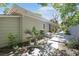 Charming backyard featuring a stone patio, lush plants, and serene landscaping at 412 43Rd Ave. N, Myrtle Beach, SC 29577