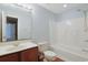 Bright bathroom with tub/shower, wood vanity, large mirror, and natural light at 412 43Rd Ave. N, Myrtle Beach, SC 29577