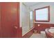 Cozy bathroom features a shower-tub combo, wood-paneling, and a tiled floor at 412 43Rd Ave. N, Myrtle Beach, SC 29577