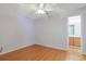 Light-filled bedroom with wood-look floors, a ceiling fan, and an en-suite bathroom entrance at 412 43Rd Ave. N, Myrtle Beach, SC 29577