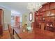 Formal dining room featuring rich hardwood floors, built-in shelving, and a view of the front entrance at 412 43Rd Ave. N, Myrtle Beach, SC 29577