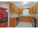 Functional kitchen featuring tile floors, wood cabinets, and essential appliances for everyday cooking and meal preparation at 412 43Rd Ave. N, Myrtle Beach, SC 29577